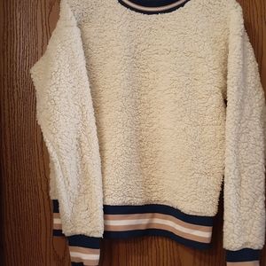 White Sweater with blue and pink ascents.